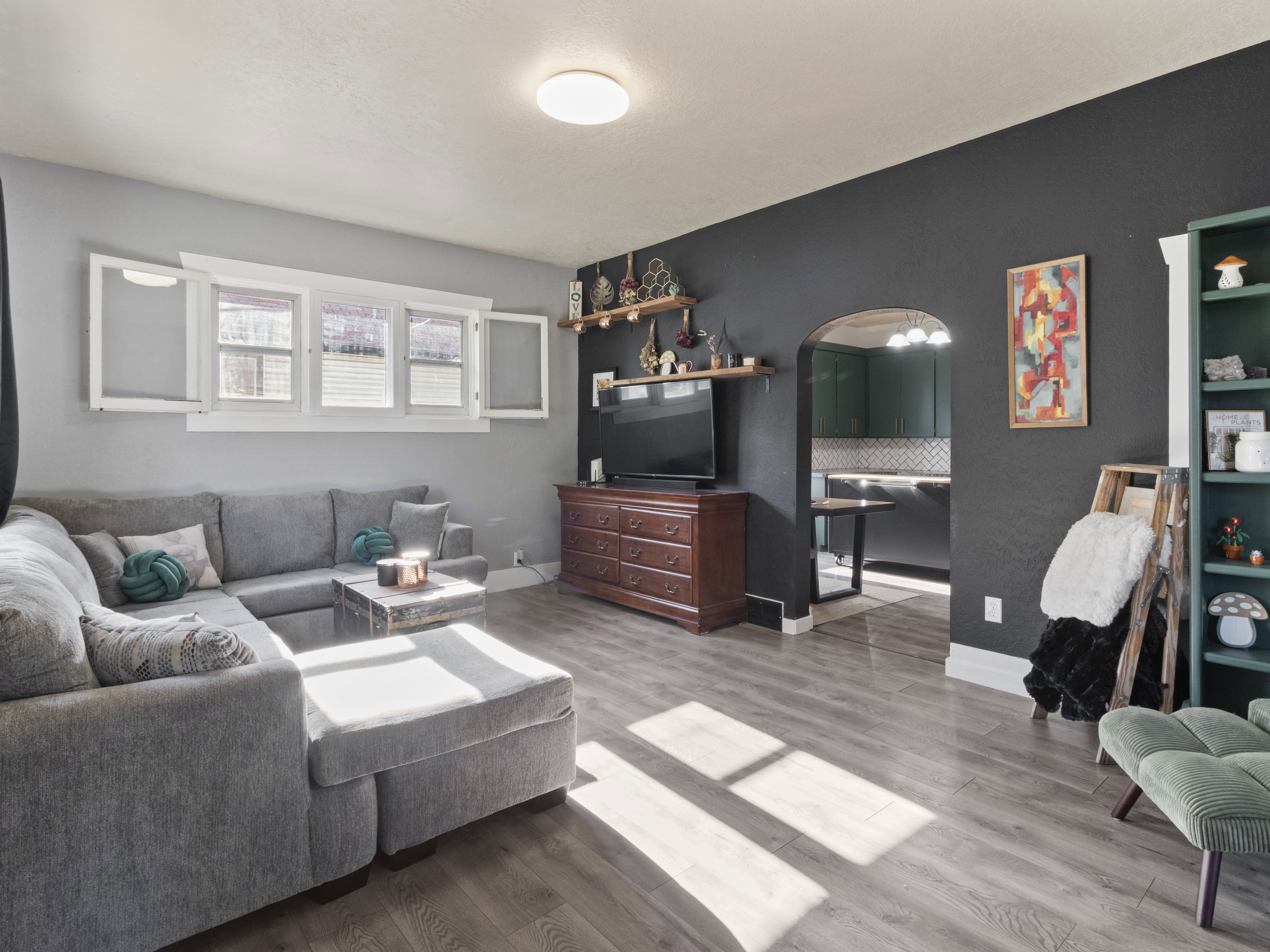 Living room with wood finished floors and arched walkways