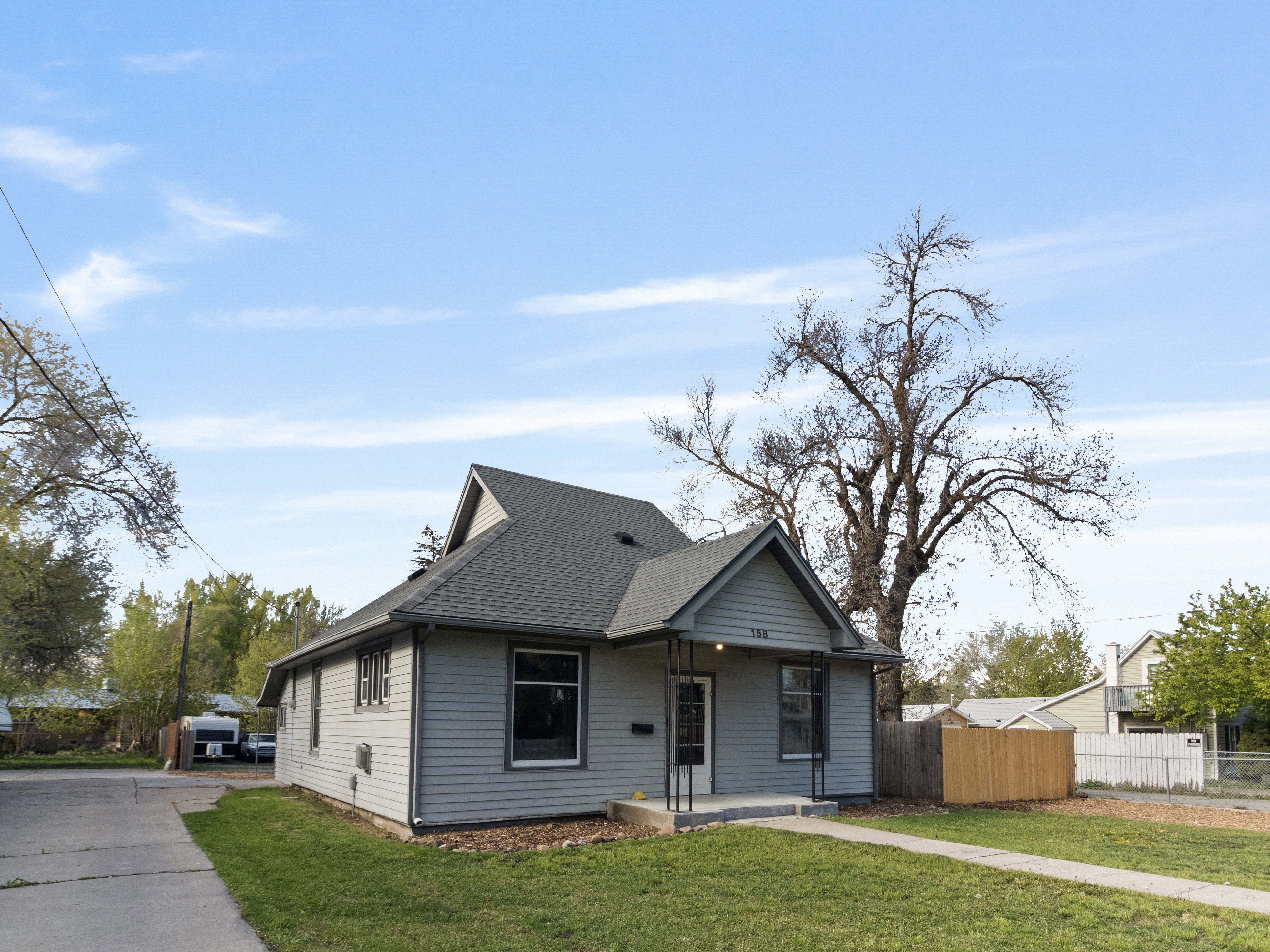Bungalow-style house with a shingled roof and covered porch