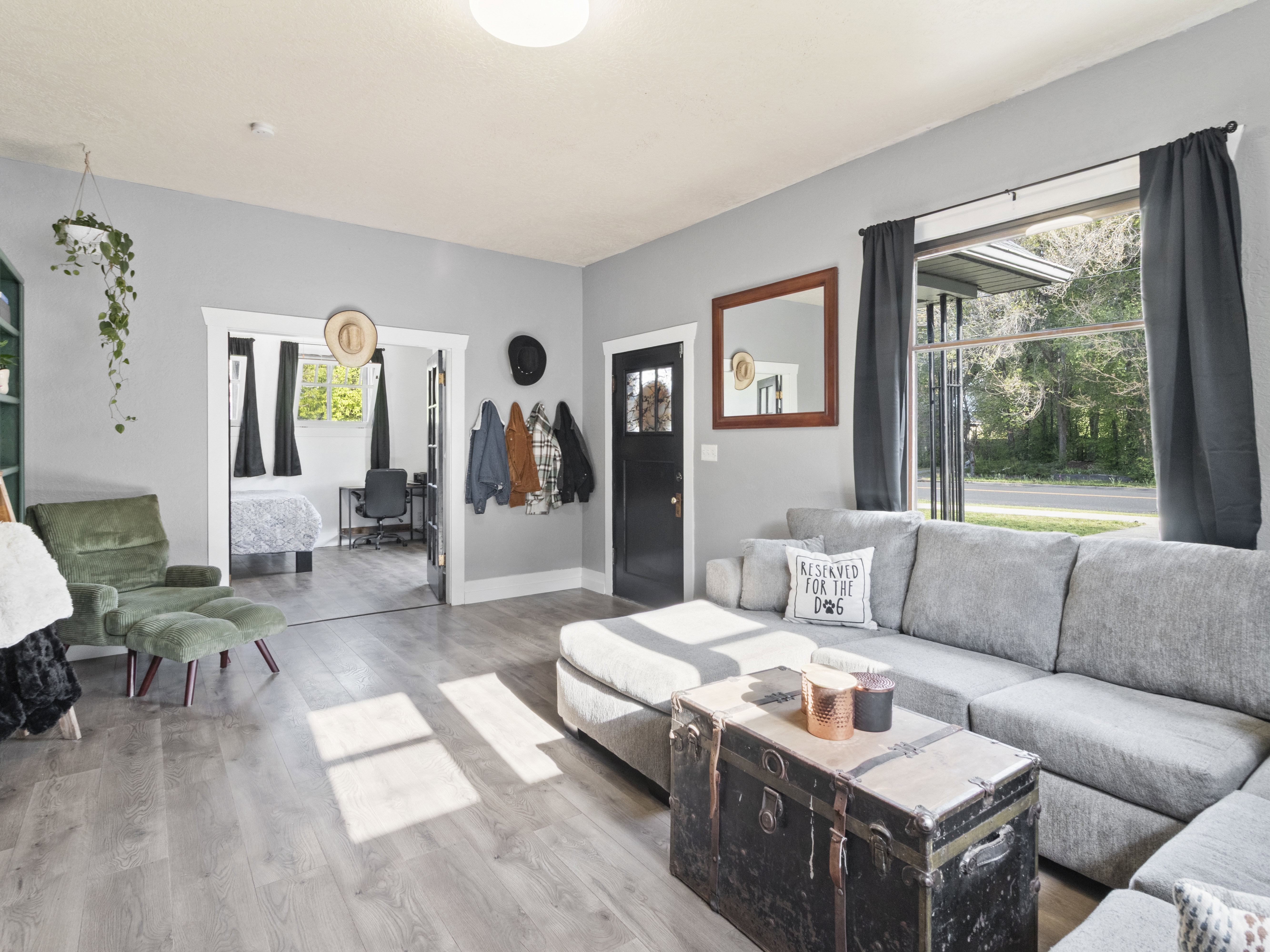 Living area with light wood-style flooring and baseboards
