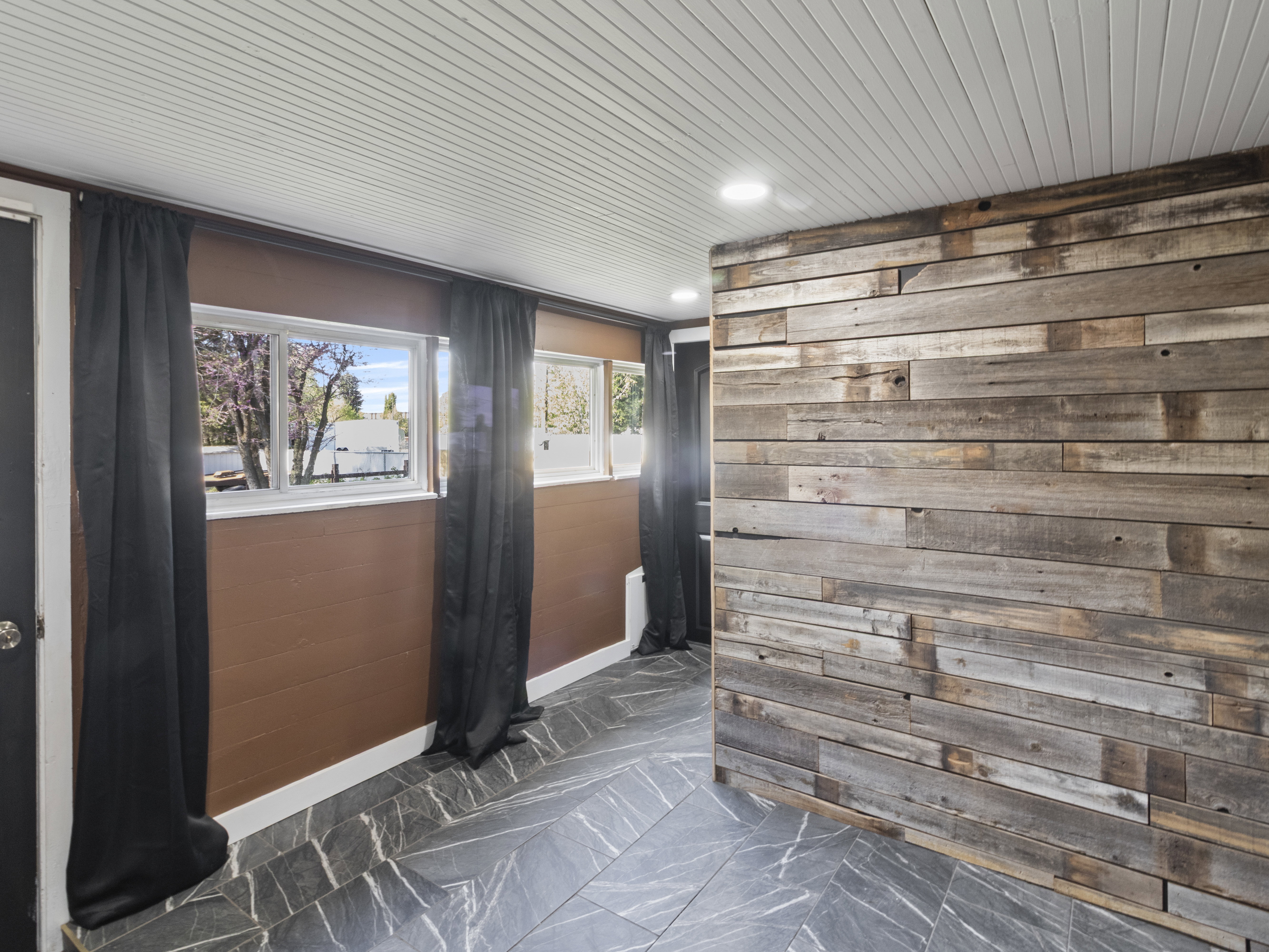 Foyer with wooden walls and recessed lighting