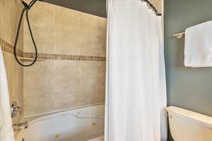 Full bathroom featuring a combined bath / shower with jetted tub