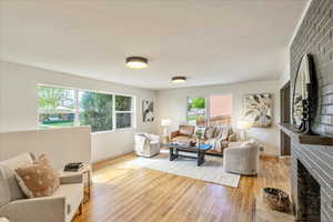 Living room with light wood finished floors and a fireplace