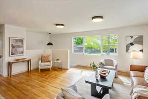 Living room featuring light wood-style floors and baseboards