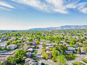 Aerial perspective of suburban area with a mountainous background