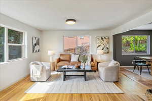 Living room with light wood-style floors and baseboards