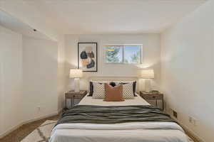 Bedroom featuring carpet floors and baseboards