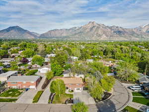 Aerial perspective of suburban area featuring a mountain backdrop