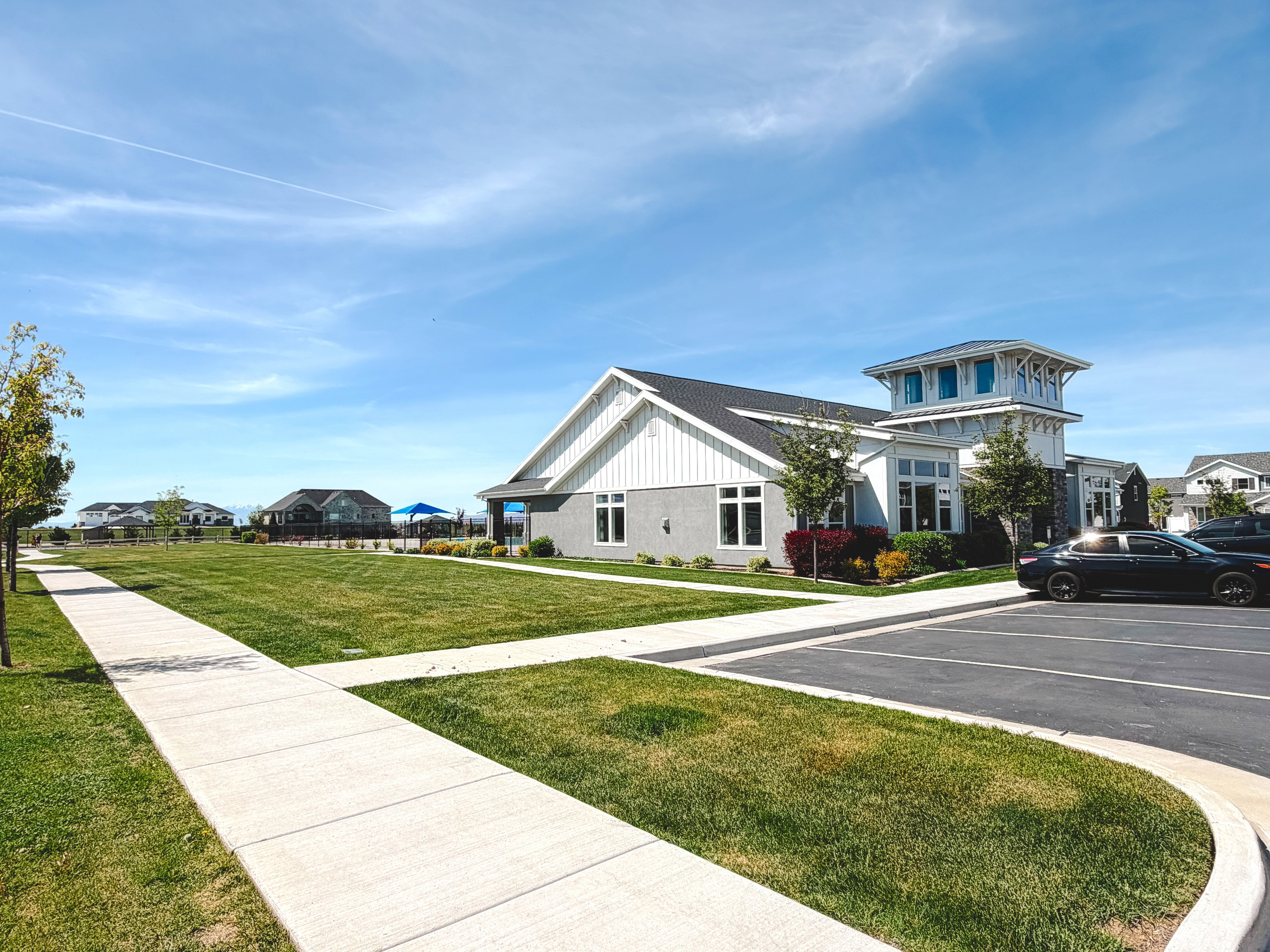 View of property exterior featuring a residential view and uncovered parking