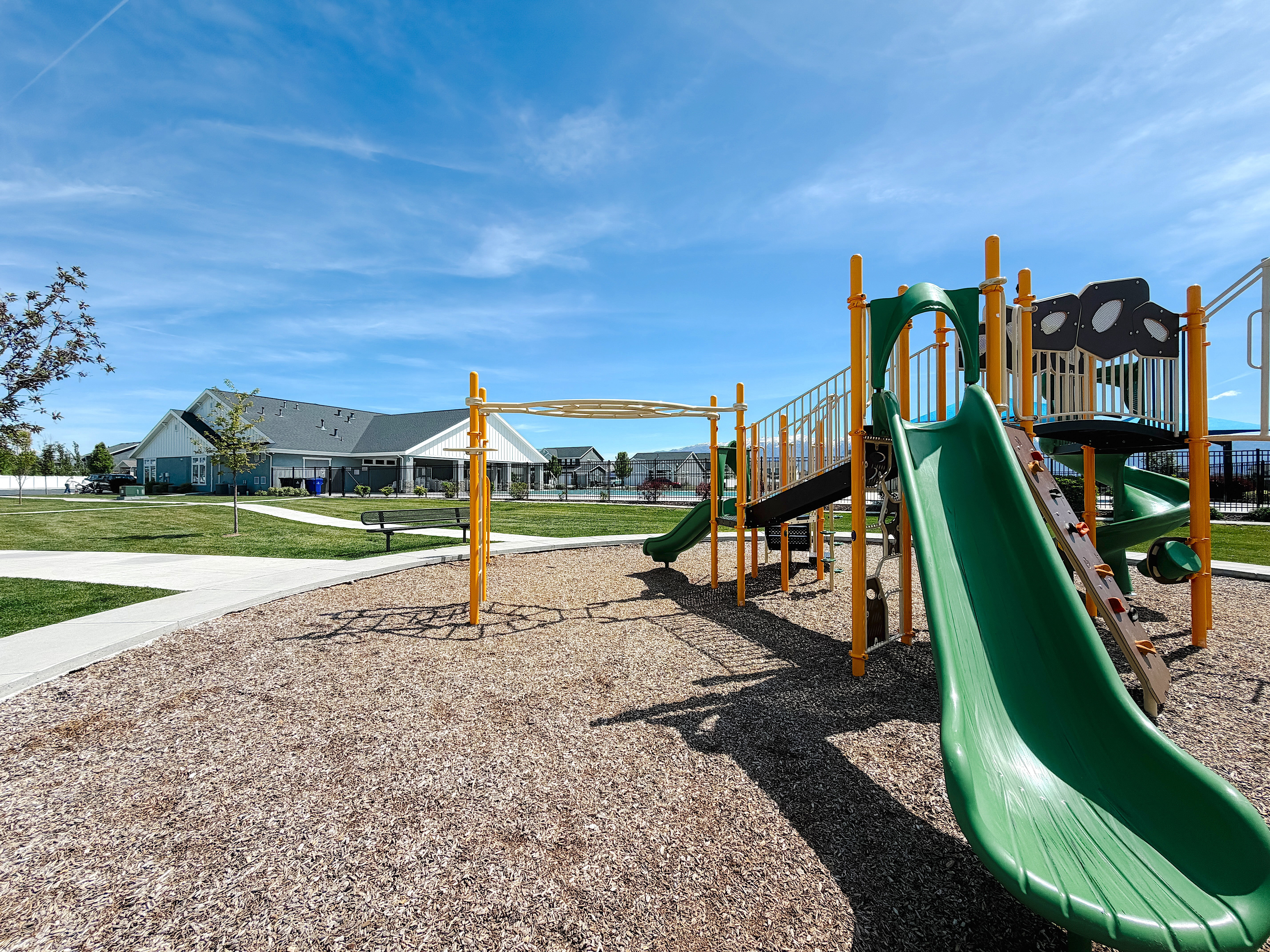 Communal playground featuring a residential view and a lawn
