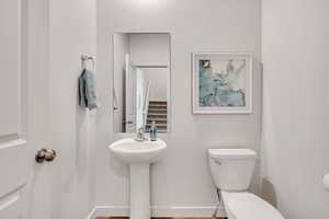 Bathroom featuring toilet and baseboards