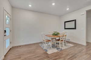 Dining area featuring light wood-style flooring and recessed lighting
