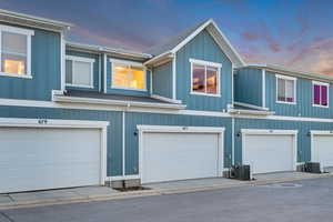 Property exterior at dusk featuring board and batten siding and a garage