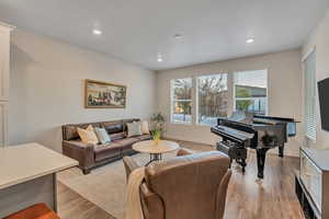 Living area featuring light wood finished floors and recessed lighting