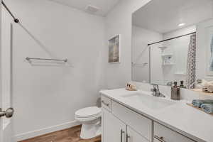 Bathroom with vanity, a shower with shower curtain, light wood-style floors, and recessed lighting