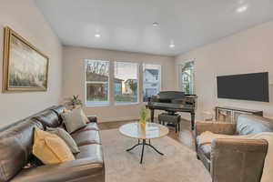 Living area featuring wood finished floors and recessed lighting