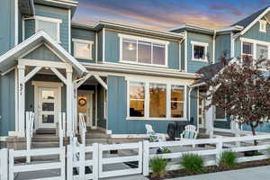 View of front of property with board and batten siding and a fenced front yard