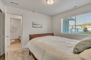 Carpeted bedroom featuring baseboards