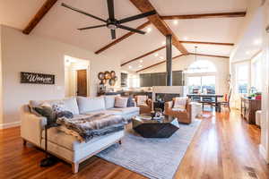 Open-concept living room with vaulted ceilings and seamless flow between kitchen, dining, and living spaces—ideal for both everyday living and entertaining