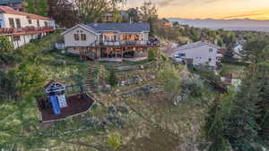 Expansive backyard with terraced landscaping and multiple outdoor living spaces, perfectly designed to take in the unobstructed mountain and valley views