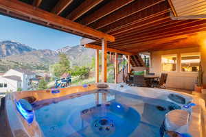 Private patio retreat with hot tub, surrounded by mountain views—perfect for year-round relaxation