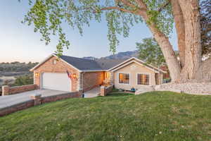 Beautifully positioned on the Sandy East Bench, this home offers timeless curb appeal with mature landscaping, a private setting, and direct access to nearby trails
