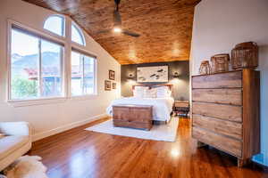Spacious and serene primary suite with large windows that capture stunning natural light and peaceful views, along with direct walkout access to the deck