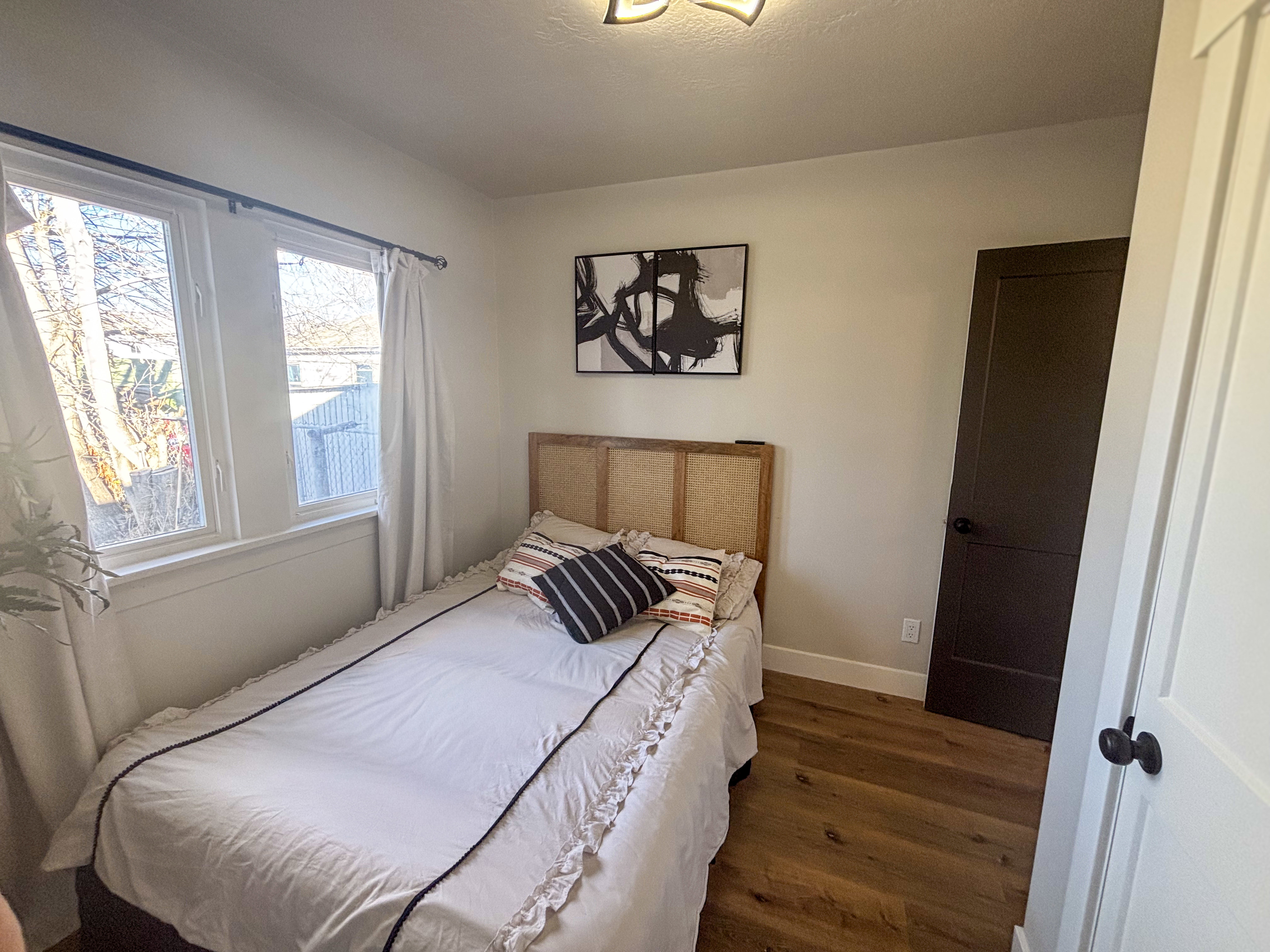 Bedroom with baseboards and wood finished floors