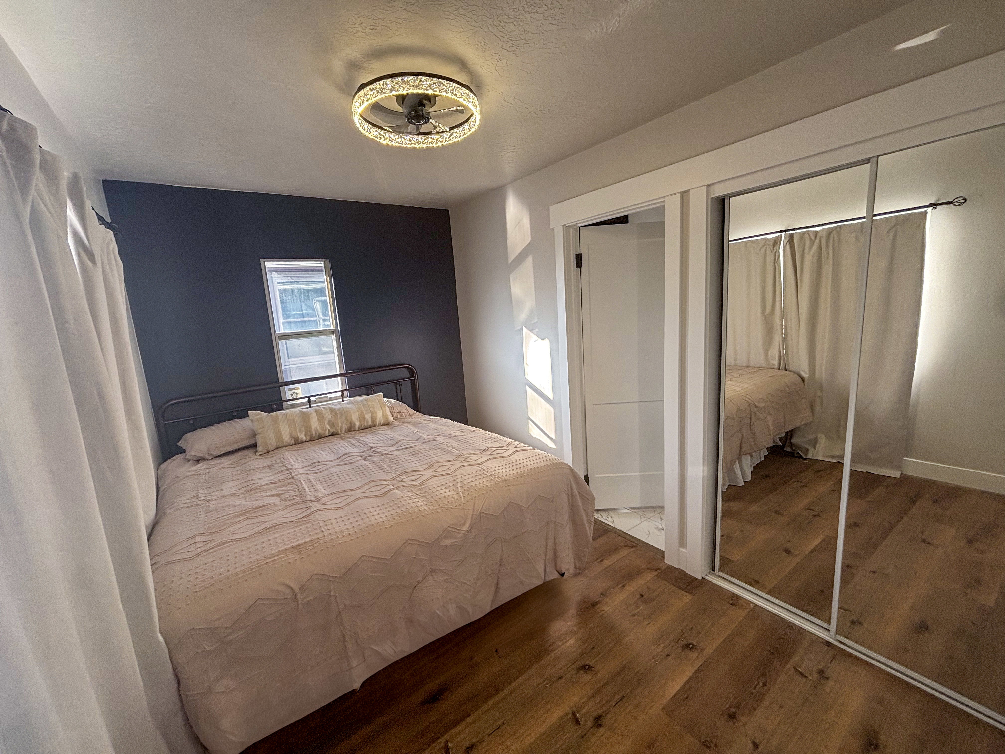 Bedroom featuring wood-type flooring, a textured ceiling, and a closet