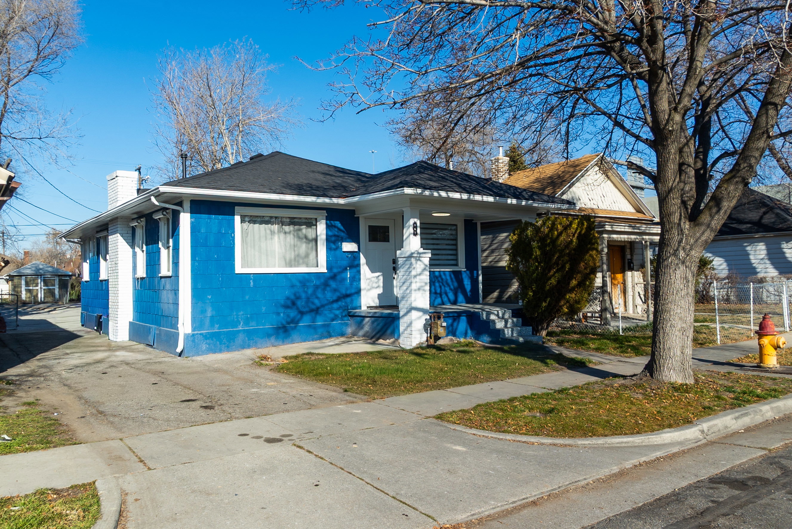 Bungalow with a chimney, concrete block siding, and driveway