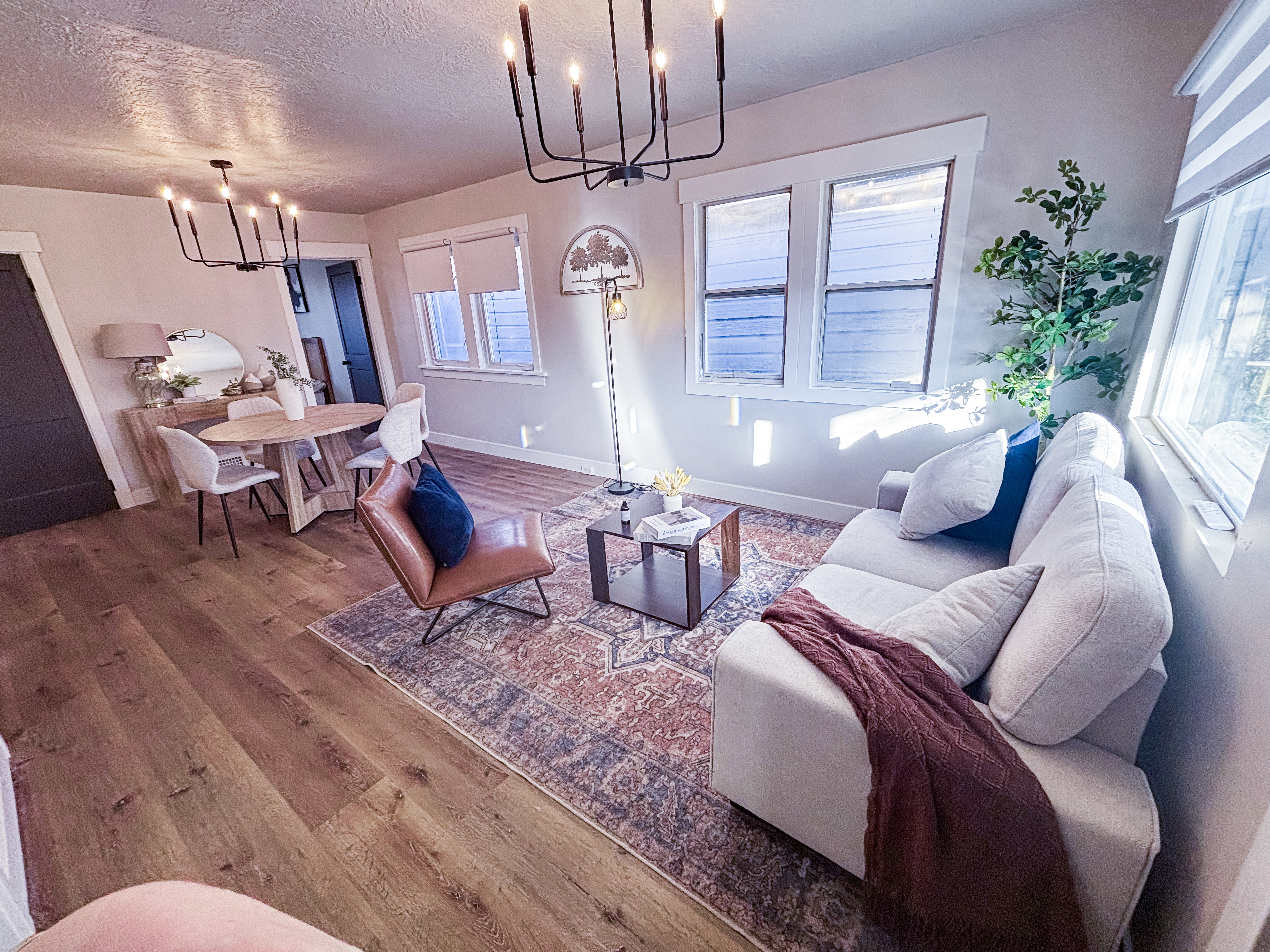 Living room featuring a chandelier, hardwood / wood-style floors, and a textured ceiling
