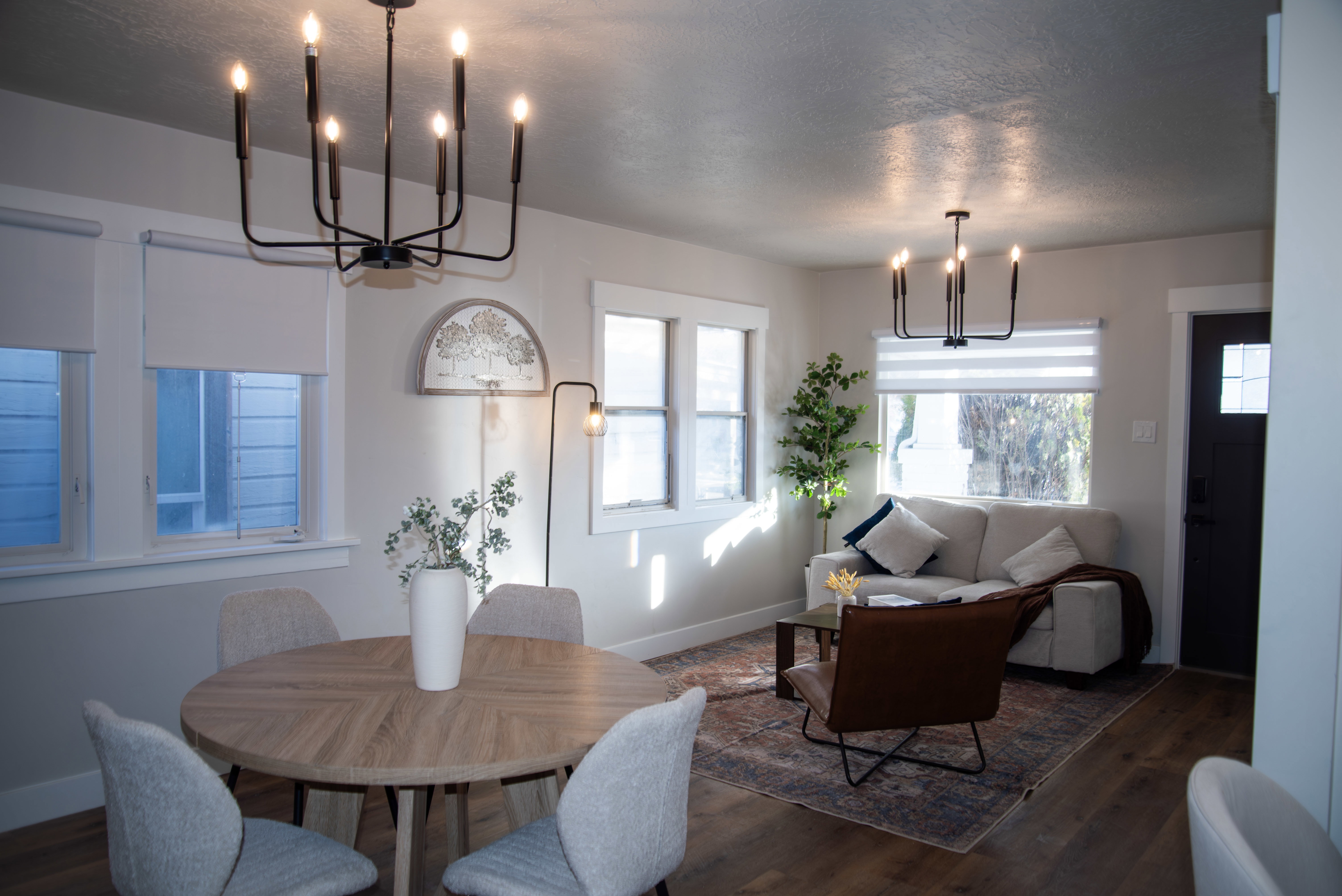 Dining room featuring a chandelier, dark wood-style floors, and a textured ceiling