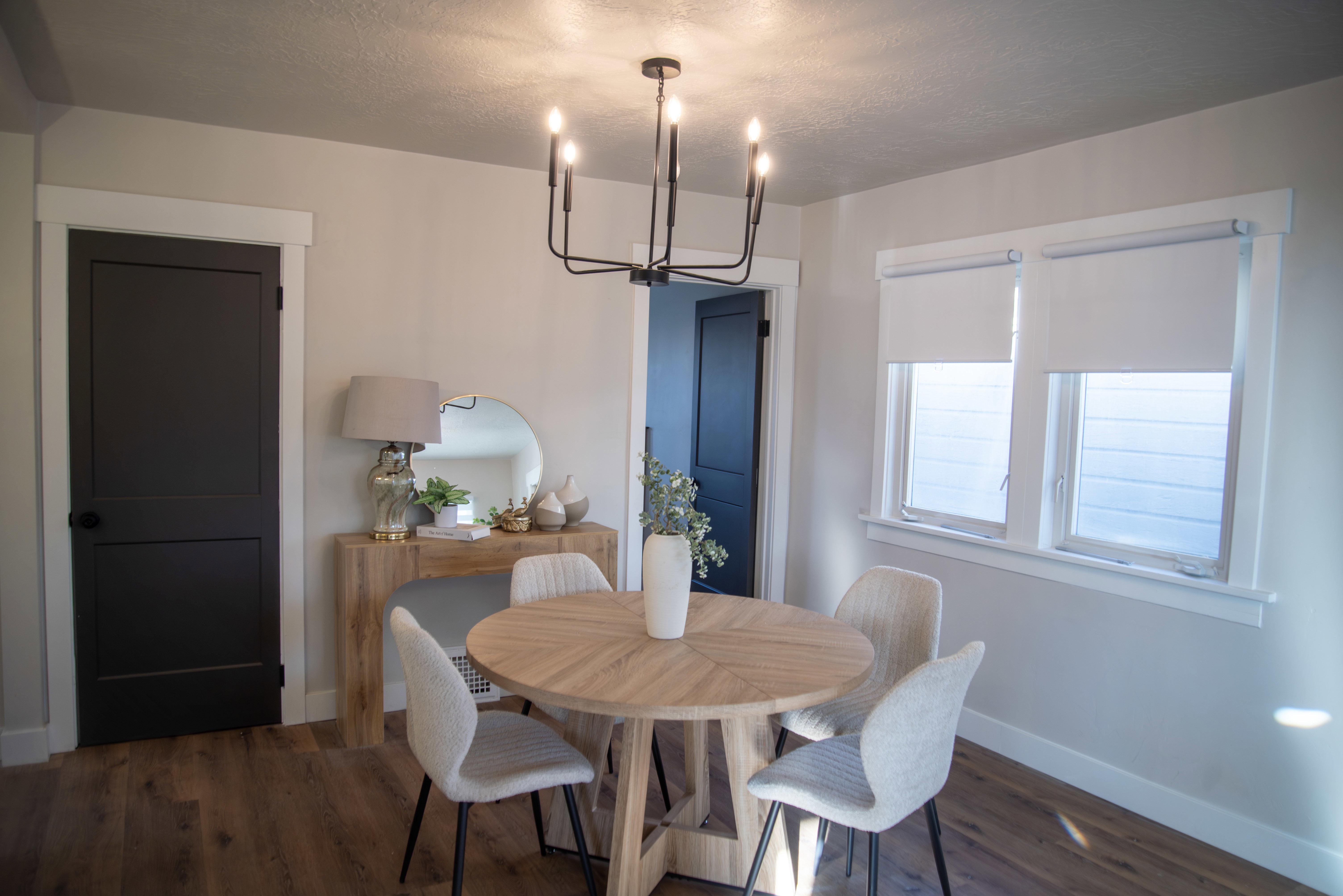 Dining area with dark wood finished floors, suspended lighting, and a textured ceiling