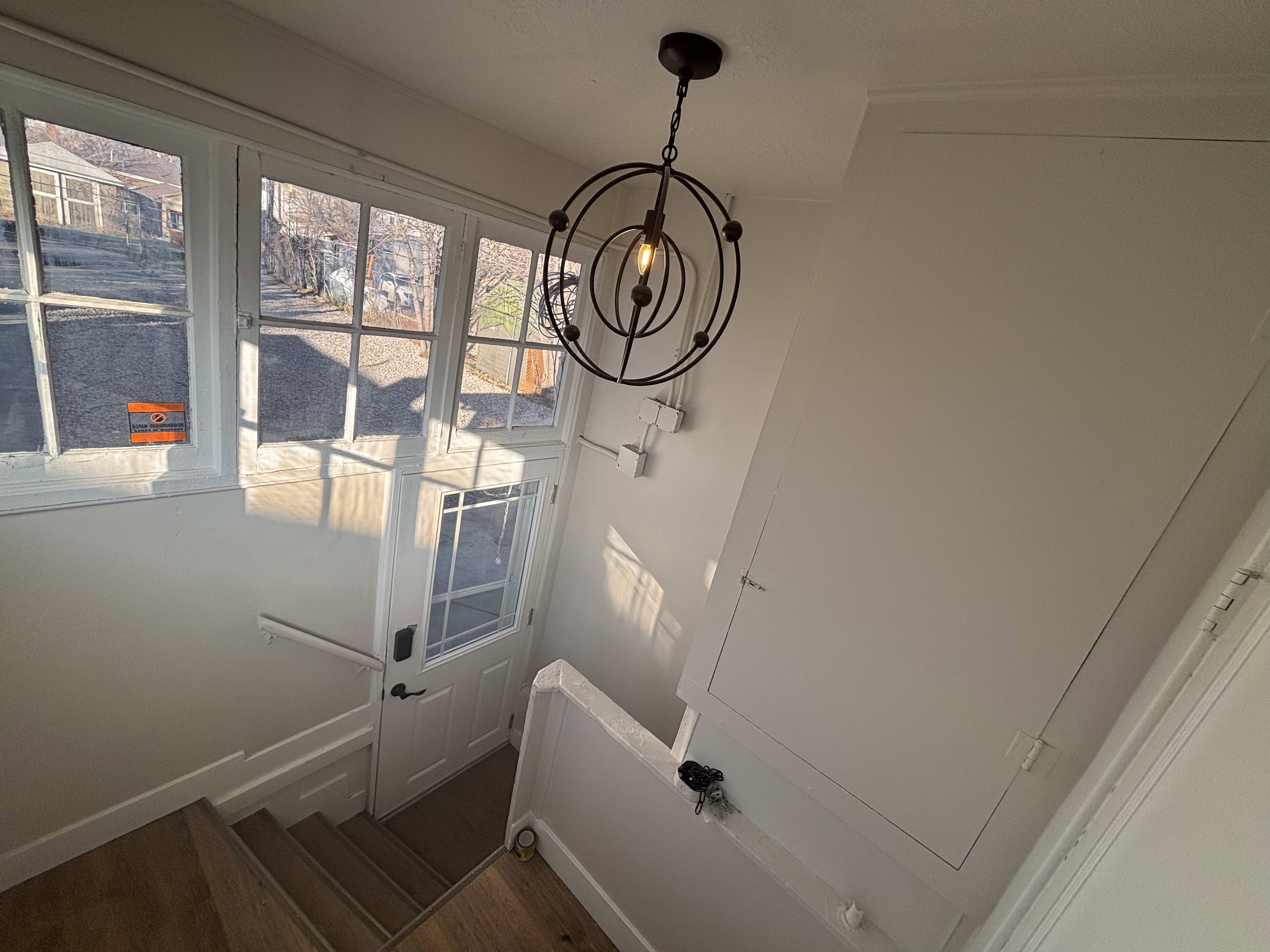 Detailed view of wood finished floors and hanging lights