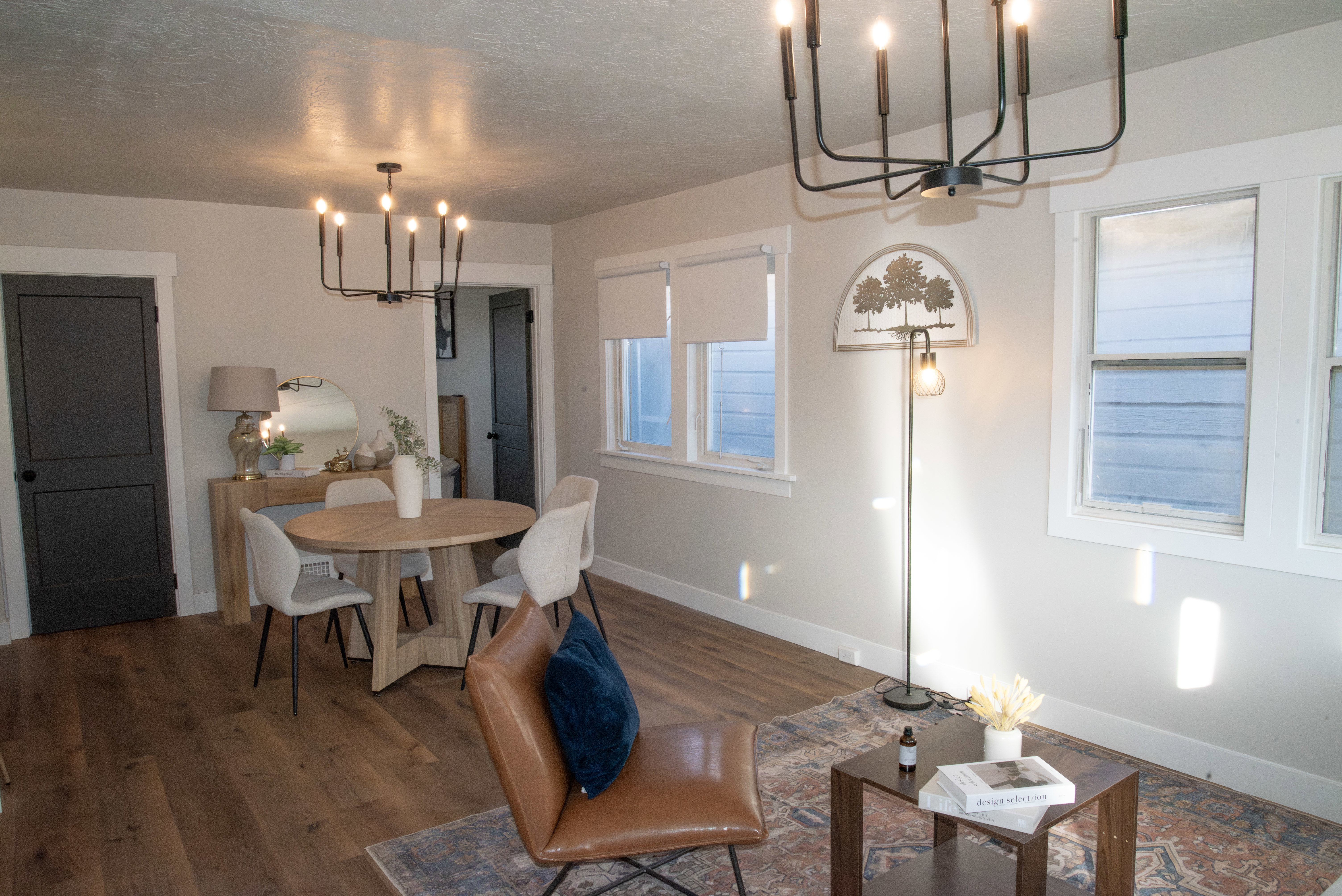 Dining space with suspended lighting, dark wood-style floors, and a textured ceiling