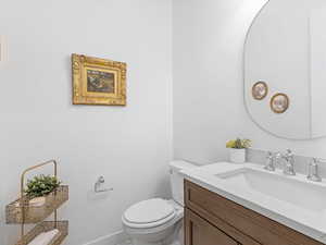 Half bath with vanity and toilet