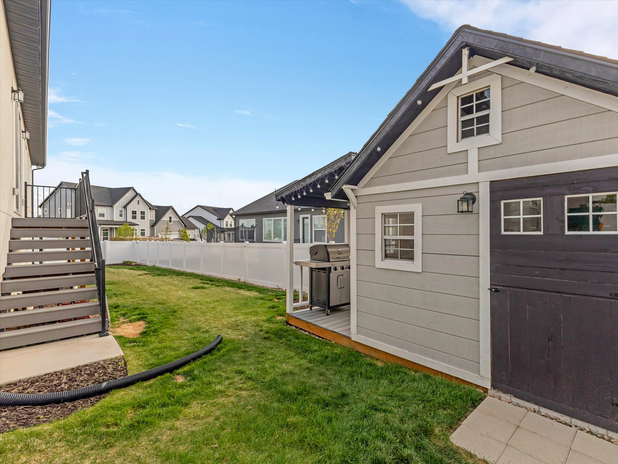 Fenced backyard with a residential view and a wooden deck