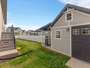Fenced backyard with a residential view and a wooden deck