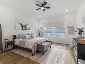 Bedroom featuring light wood-type flooring, a ceiling fan, and recessed lighting
