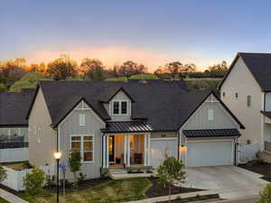 Modern farmhouse featuring a standing seam roof, board and batten siding, a shingled roof, and a porch