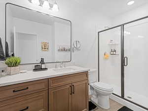 Full bathroom with vanity, a shower stall, and light tile patterned floors