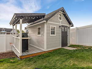 View of outdoor structure with a fenced backyard