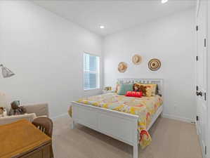Carpeted bedroom featuring baseboards and recessed lighting