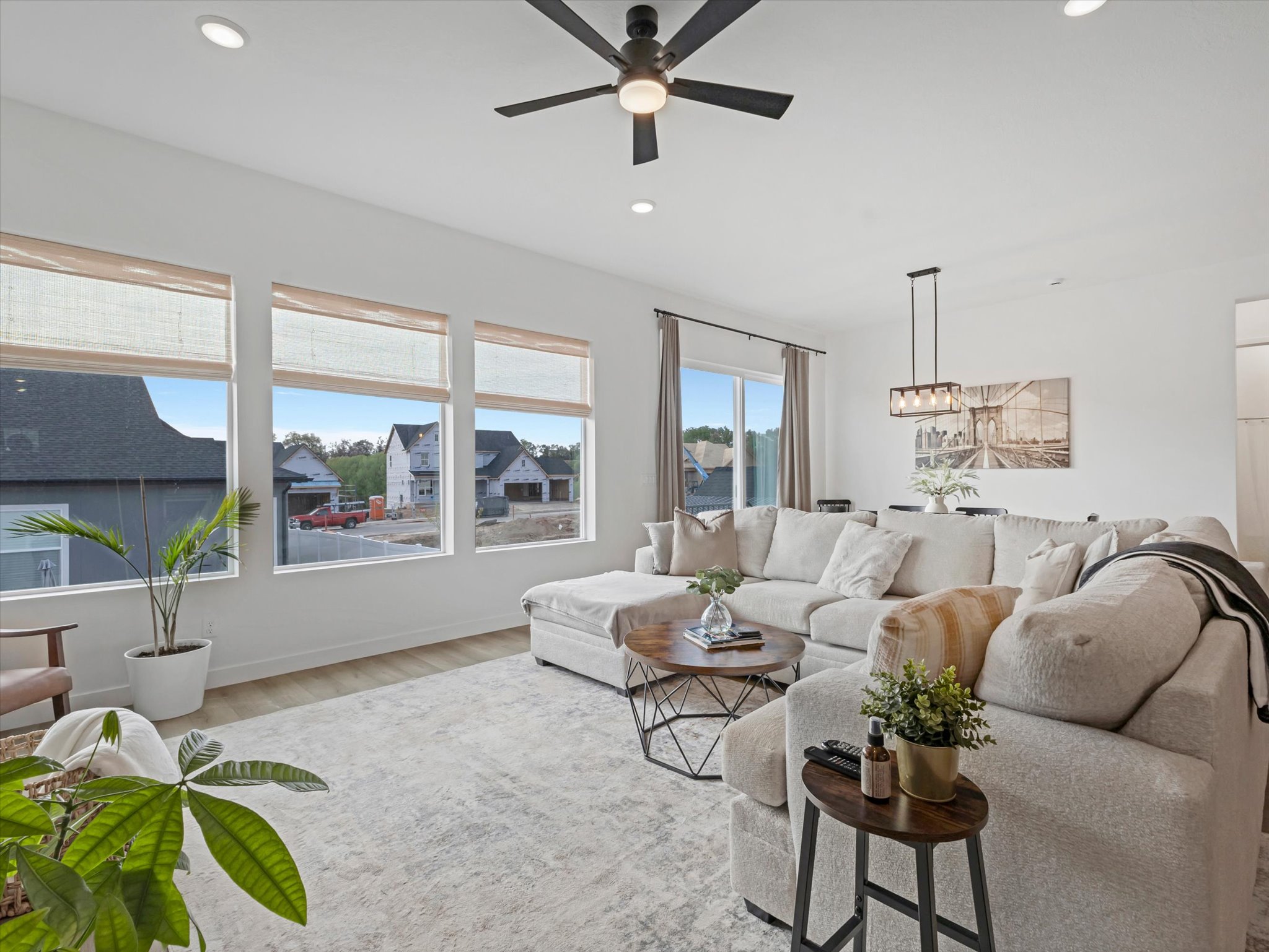 Living area with ceiling fan, light wood-style floors, and recessed lighting
