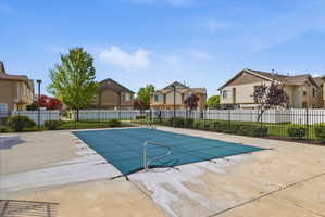 Community pool featuring a residential view