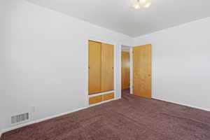 Unfurnished room featuring carpet flooring and baseboards