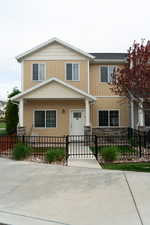 View of front facade featuring a gate, a fenced front yard, and board and batten siding