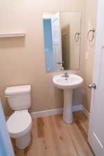 Bathroom with light wood-style floors and toilet