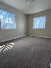 Empty room with baseboards and carpet flooring