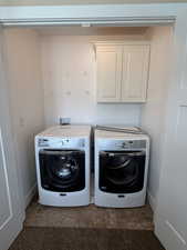 Laundry room with cabinet space and separate washer and dryer