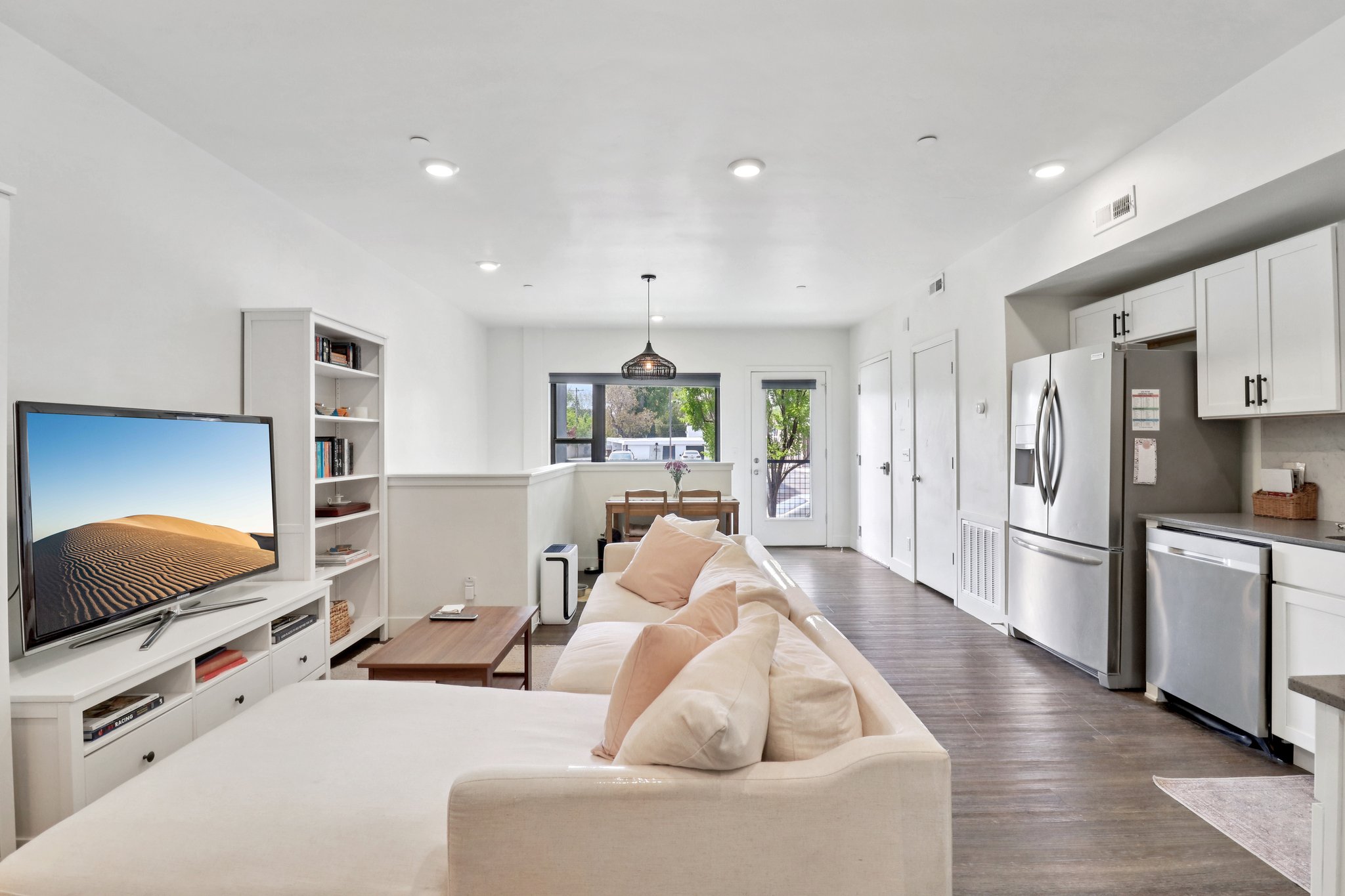 Living room with dark wood-style floors and recessed lighting